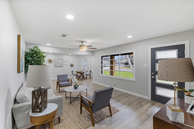 living area with recessed lighting, visible vents, light wood-style flooring, ceiling fan, and baseboards