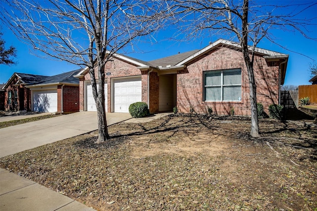 single story home with a garage, fence, concrete driveway, and brick siding