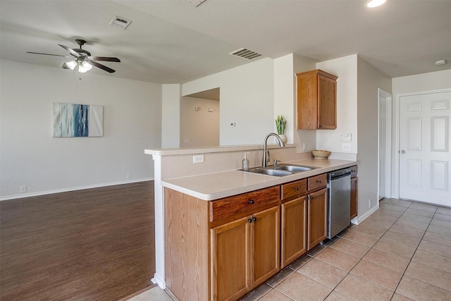 kitchen featuring light countertops, visible vents, a sink, and stainless steel dishwasher