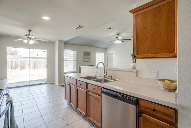 kitchen with brown cabinetry, visible vents, a sink, and stainless steel dishwasher