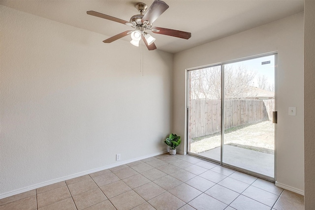 unfurnished room featuring light tile patterned floors, ceiling fan, and baseboards