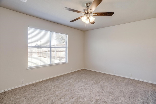 empty room with ceiling fan, carpet, and baseboards