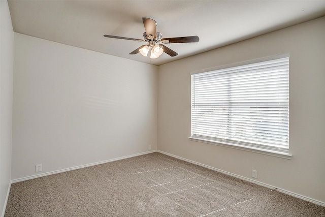 unfurnished room featuring a ceiling fan, carpet, and baseboards