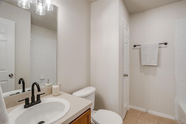 bathroom with tile patterned flooring, baseboards, vanity, and toilet