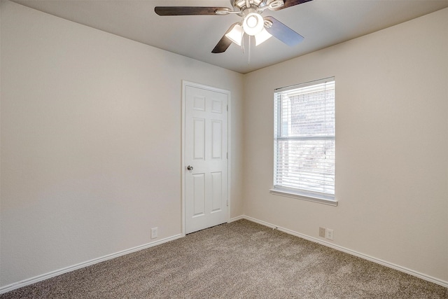 unfurnished room with light colored carpet, ceiling fan, and baseboards