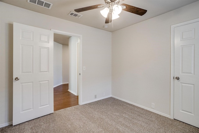 unfurnished bedroom featuring baseboards, visible vents, and carpet flooring