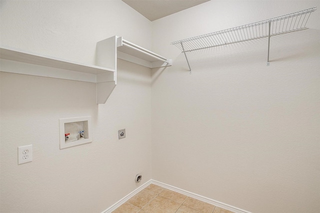 washroom with light tile patterned floors, hookup for a washing machine, hookup for an electric dryer, laundry area, and baseboards