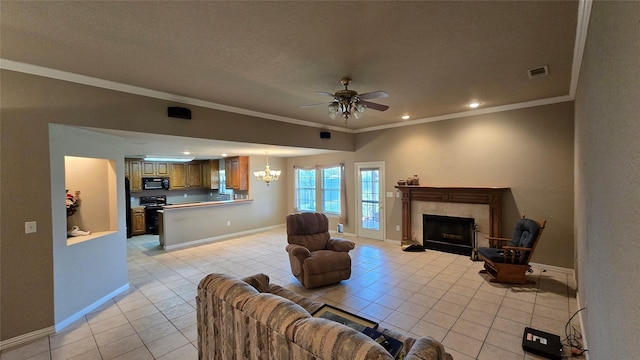 living room featuring light tile patterned floors, ornamental molding, ceiling fan with notable chandelier, and a tiled fireplace