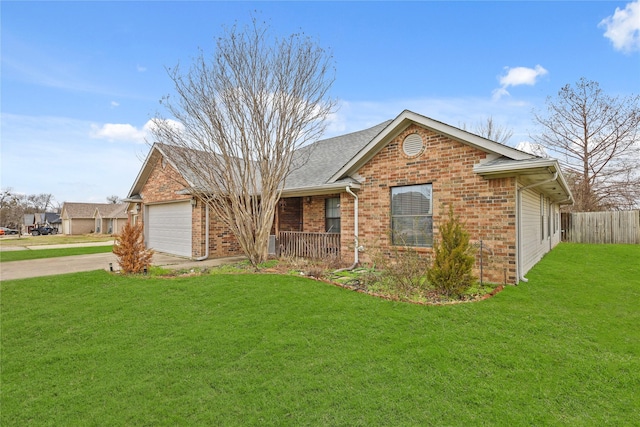 ranch-style house with an attached garage, brick siding, fence, driveway, and a front lawn