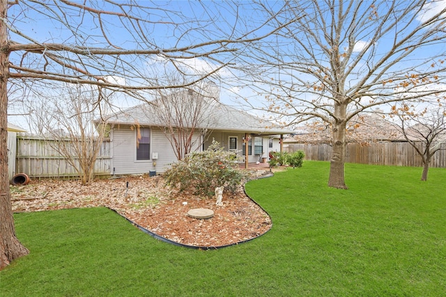 exterior space featuring a yard, a shingled roof, and a fenced backyard