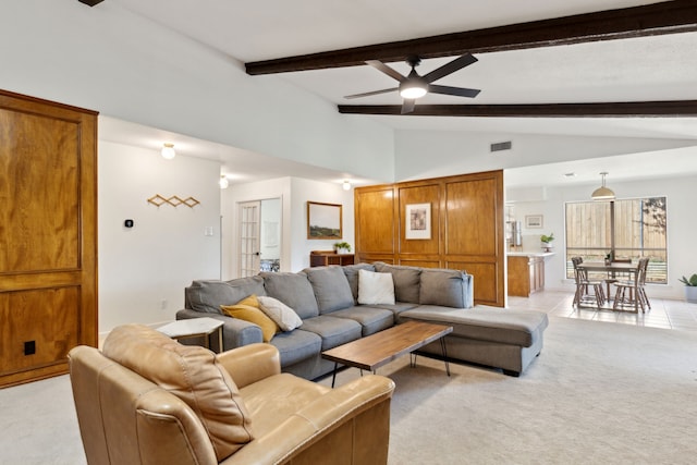 living room featuring vaulted ceiling with beams, visible vents, light tile patterned flooring, light carpet, and ceiling fan