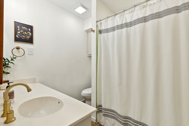 bathroom featuring toilet, a shower with curtain, and vanity