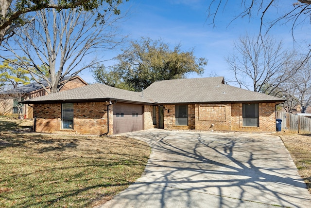 single story home with an attached garage, a shingled roof, concrete driveway, and brick siding