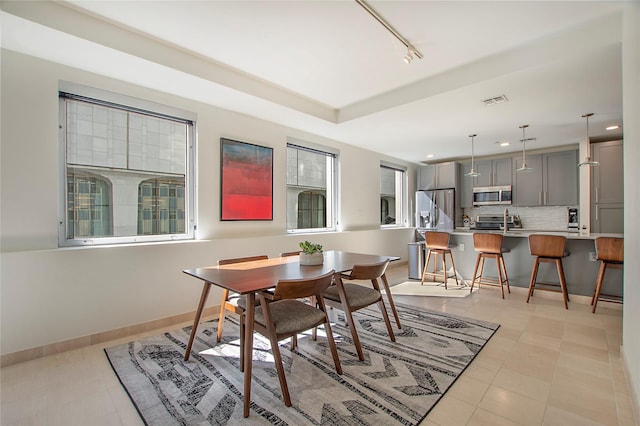 dining area with light tile patterned floors, recessed lighting, rail lighting, visible vents, and baseboards