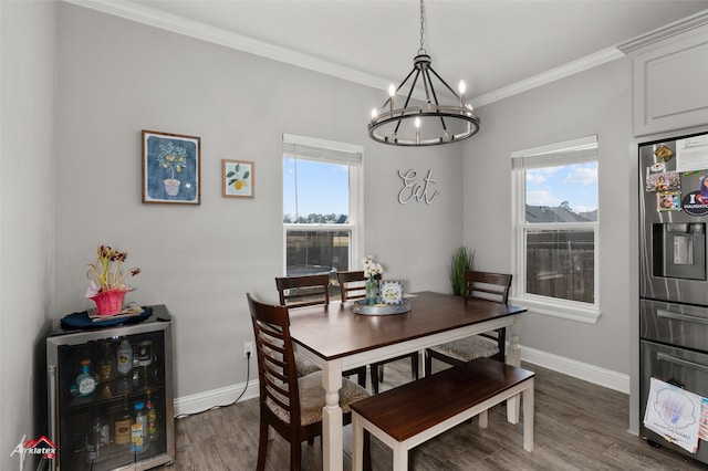 dining area with beverage cooler, baseboards, crown molding, and wood finished floors