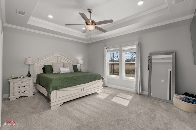 bedroom with a raised ceiling, visible vents, ornamental molding, carpet flooring, and baseboards