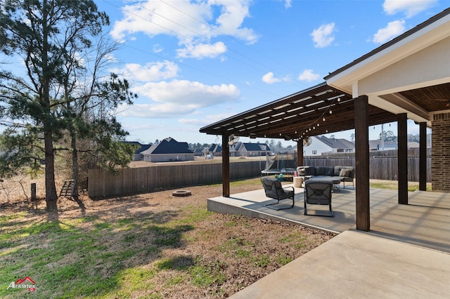 view of yard featuring a patio area, a fenced backyard, and an outdoor living space with a fire pit