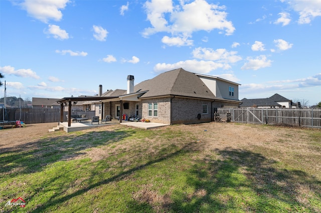 back of property featuring a trampoline, brick siding, a lawn, a patio area, and a fenced backyard