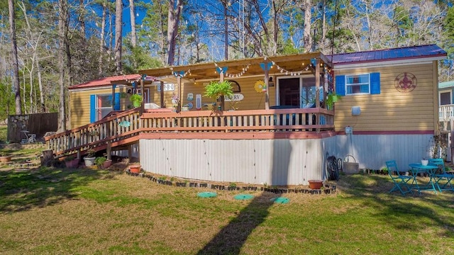 505 County Road 3420, Hawkins, TX 75765 - back of house featuring metal roof, a deck, and a yard