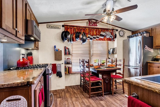 505 County Road 3420, Hawkins, TX 75765 - kitchen featuring lofted ceiling, dark wood-style flooring, appliances with stainless steel finishes, brown cabinetry, and crown molding