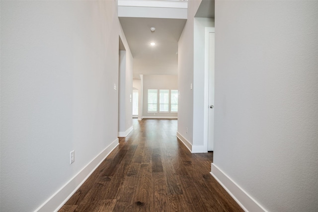 corridor featuring dark wood-style floors and baseboards