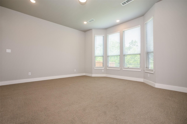 spare room with baseboards, carpet, visible vents, and recessed lighting