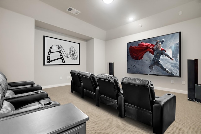 cinema room featuring light carpet, visible vents, and baseboards