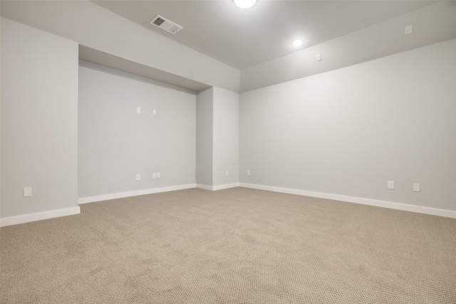 empty room featuring baseboards, visible vents, and carpet flooring