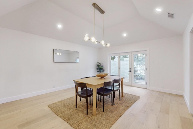 dining space featuring lofted ceiling, french doors, visible vents, and light wood-style floors