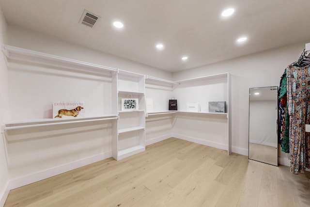 spacious closet with light wood-style floors and visible vents