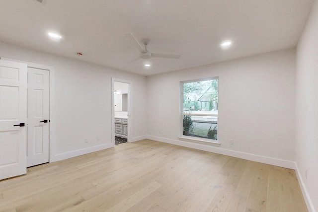 empty room with baseboards, recessed lighting, a ceiling fan, and light wood-style floors