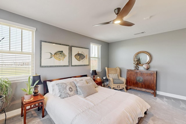 carpeted bedroom featuring visible vents, ceiling fan, and baseboards