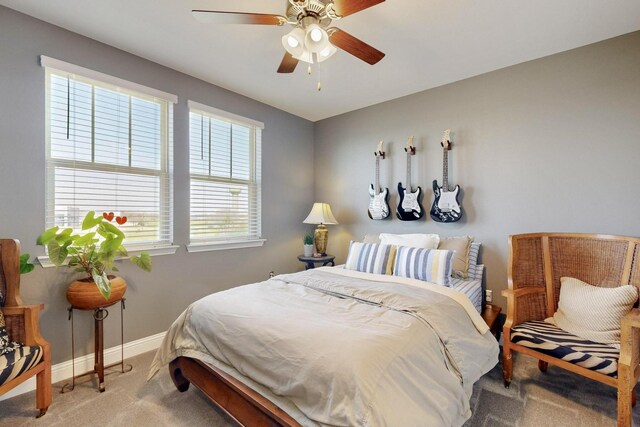 carpeted bedroom with a ceiling fan, baseboards, and visible vents