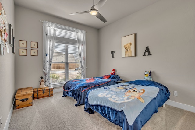 bedroom with ceiling fan, carpet flooring, and baseboards