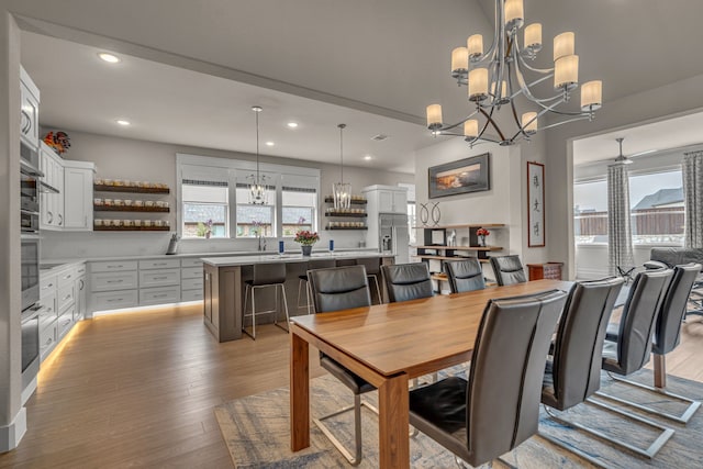 dining space featuring light wood-type flooring, a healthy amount of sunlight, ceiling fan, and recessed lighting