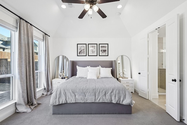 carpeted bedroom featuring ceiling fan, vaulted ceiling, and connected bathroom