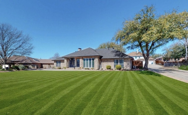 1721 Plummer Dr, Rockwall, TX 75087 - view of front of house featuring driveway, a front yard, and an attached garage