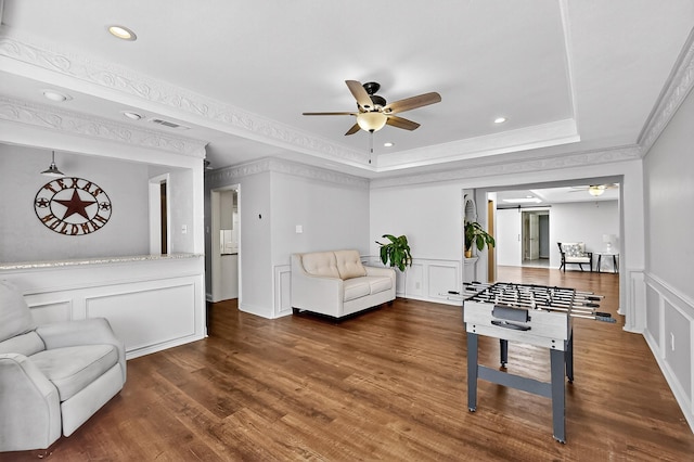 1721 Plummer Dr, Rockwall, TX 75087 - playroom featuring a ceiling fan, a decorative wall, a raised ceiling, wood finished floors, and ornamental molding
