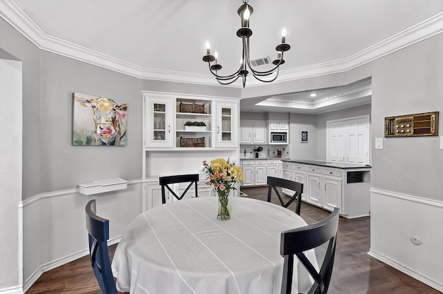 1721 Plummer Dr, Rockwall, TX 75087 - dining room with ornamental molding, a chandelier, dark wood-type flooring, and a tray ceiling