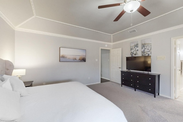 bedroom with visible vents, ornamental molding, a tray ceiling, carpet, and vaulted ceiling