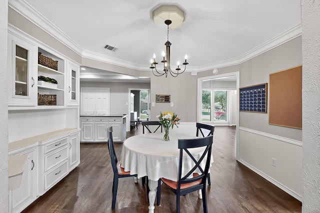 1721 Plummer Dr, Rockwall, TX 75087 - dining room featuring crown molding, dark wood finished floors, and a chandelier