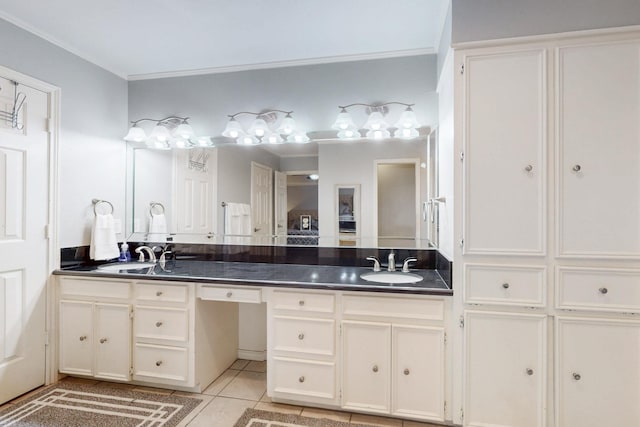 full bath with a sink, ornamental molding, double vanity, and tile patterned flooring