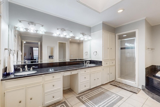 bathroom with tile patterned flooring, crown molding, and a sink