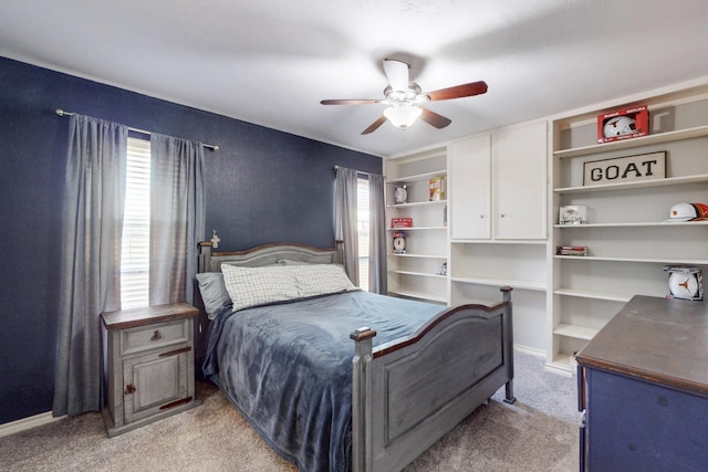 bedroom with light carpet, baseboards, and a ceiling fan