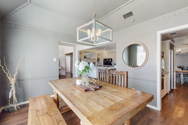 dining space featuring a notable chandelier, visible vents, crown molding, and dark wood-type flooring