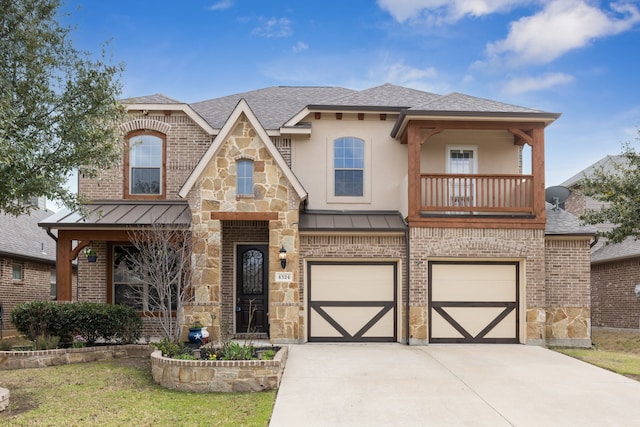 view of front of house with a garage, driveway, a standing seam roof, and a balcony