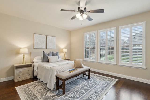 bedroom featuring dark wood-style flooring, multiple windows, ceiling fan, and baseboards