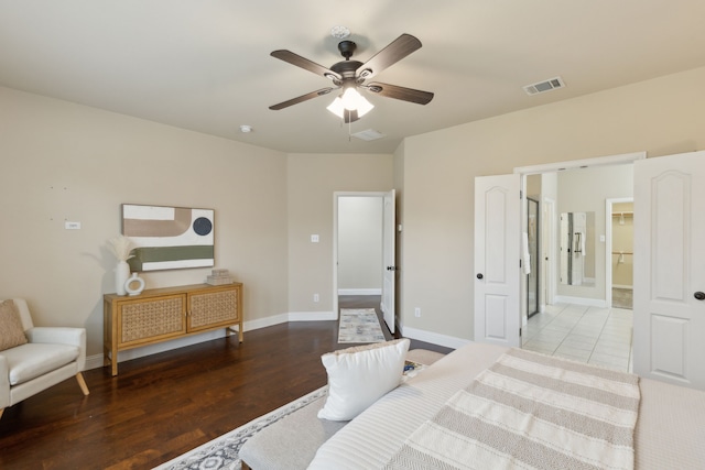 bedroom with a ceiling fan, baseboards, visible vents, and wood finished floors