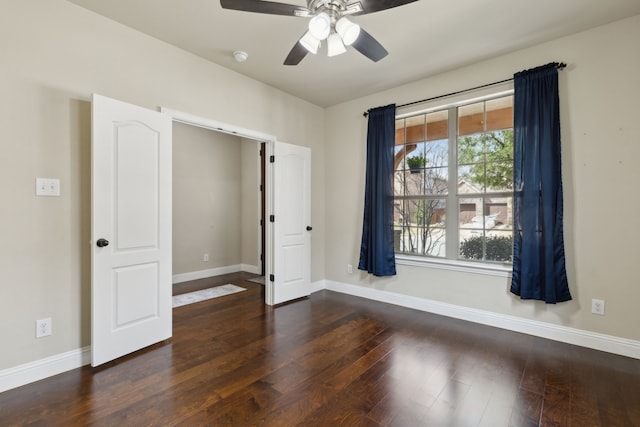 unfurnished room featuring ceiling fan, baseboards, and wood finished floors