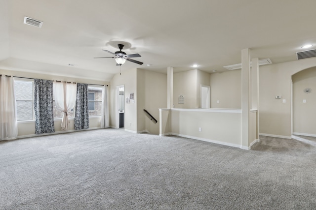 unfurnished room featuring baseboards, visible vents, arched walkways, carpet flooring, and recessed lighting